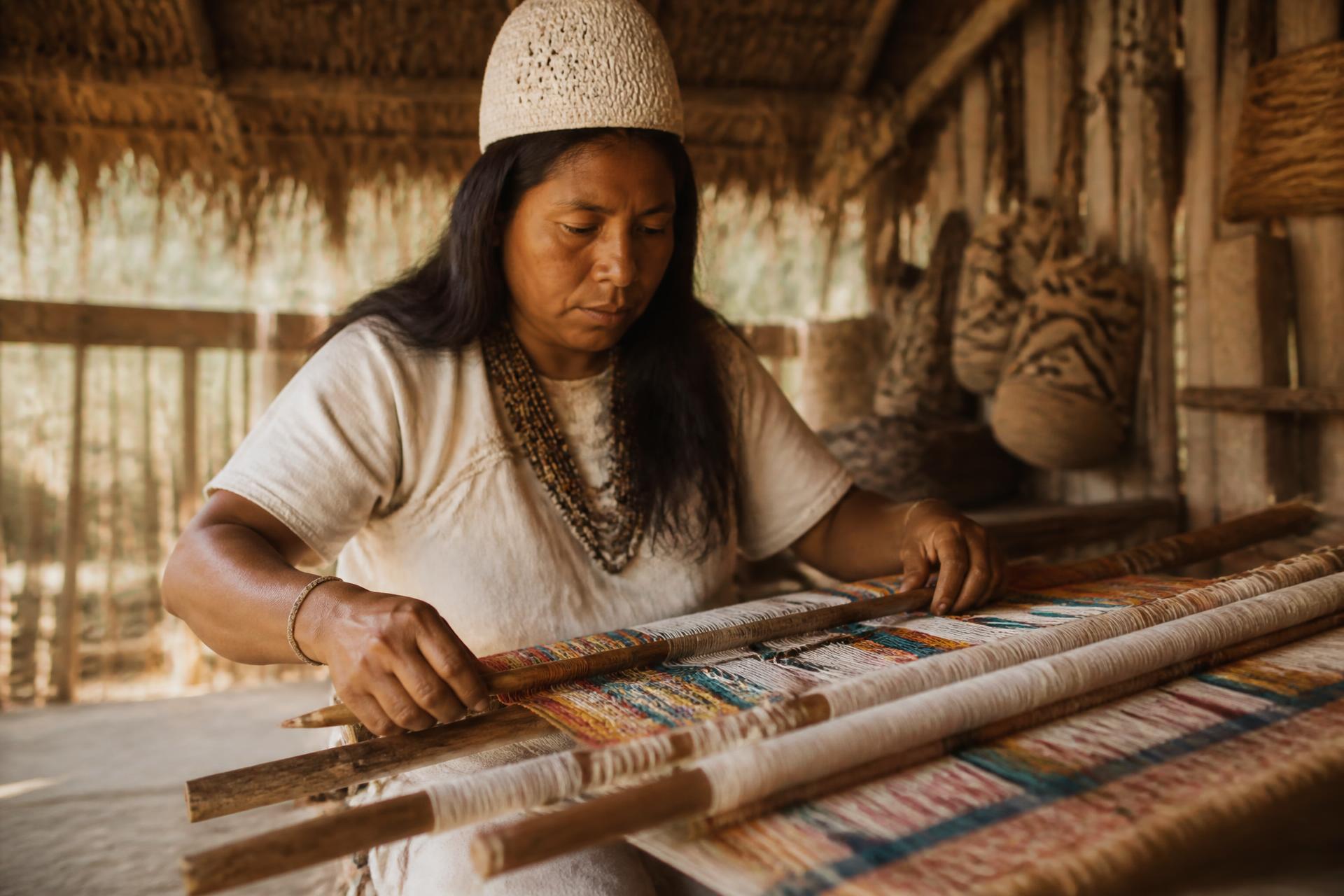 Artisan weaving on a traditional loom